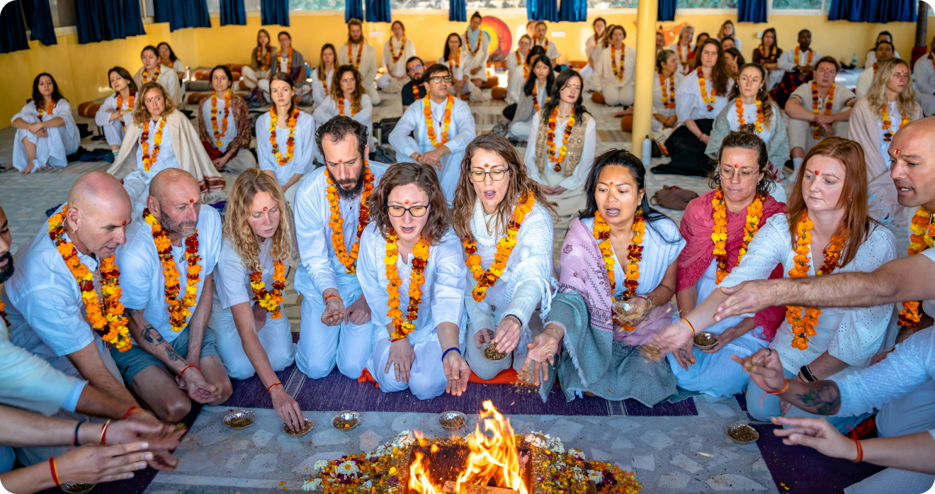 Yoga ceremony with practitioners around fire